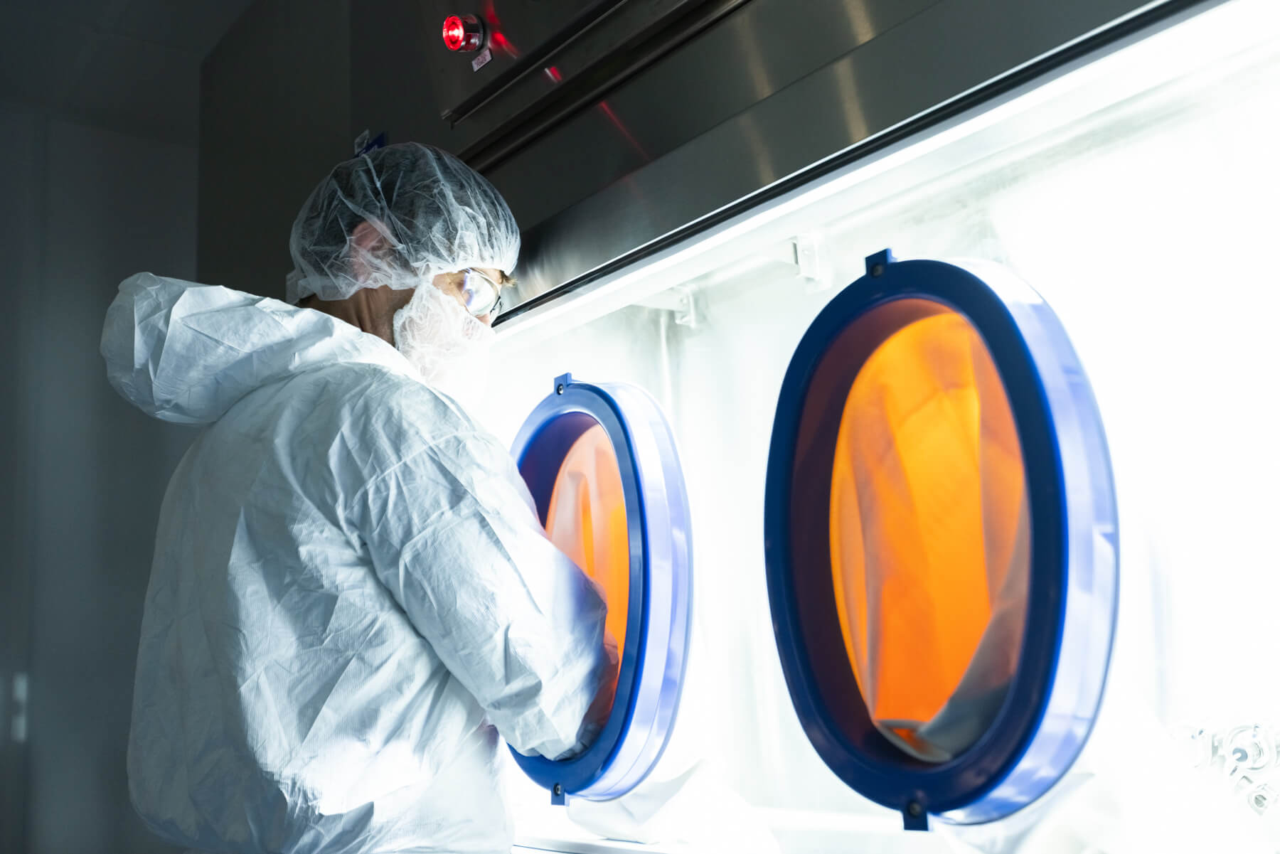 An analytical scientist working with a glove box in Gannet BioChem's laboratory
