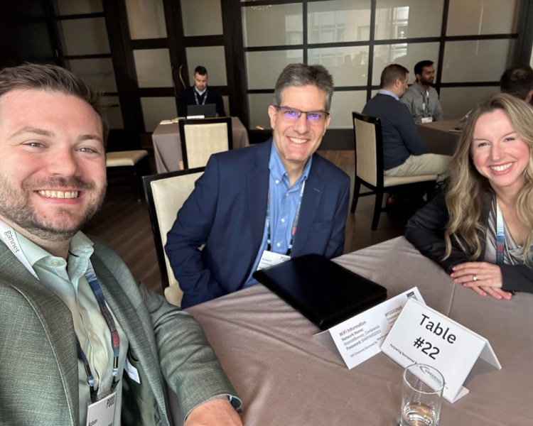 Colleagues from Gannet BioChem seated together at a conference